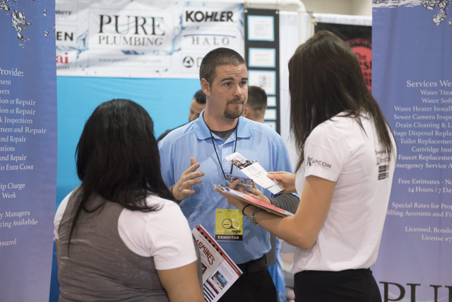 Center, Anthony Olmsted, plumber for Pure Plumbing, speaks with Carolina Quiralte, left, and Elena Rodriguez of Print 2 Life during the Las Vegas Metro Chamber Of Commerce Business Expo at Cashman ...