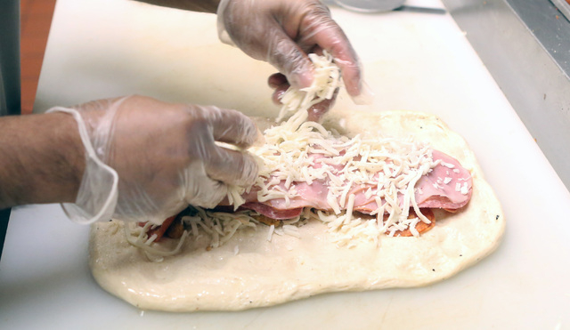 John Roncal prepares Stromboli sandwich at Four Kegs restaurant on 276 Jones Boulevard in Las Vegas. Stromboli is a type of turnover filled with mozzarella, Italian meats such as salami, pepperoni ...