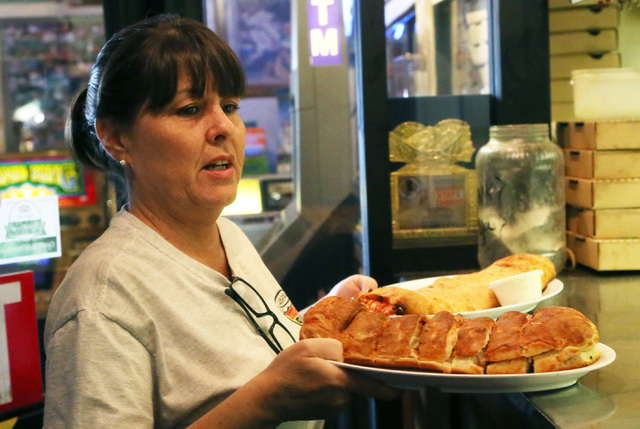 Marla Gould, a waitress at Four Kegs, takes out orders from the kitchen at the restaurant at 276 Jones Boulevard in Las Vegas on Friday, May 22, 2015. (Bizuayehu Tesfaye/Las Vegas Review-Journal)  ...