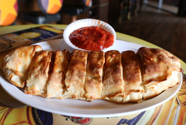 Stromboli sandwich is displayed Friday, May 22, 2015 at Four Kegs restaurant on 276 Jones Boulevard in Las Vegas. Stromboli is a type of turnover filled with mozzarella, Italian meats such as sala ...