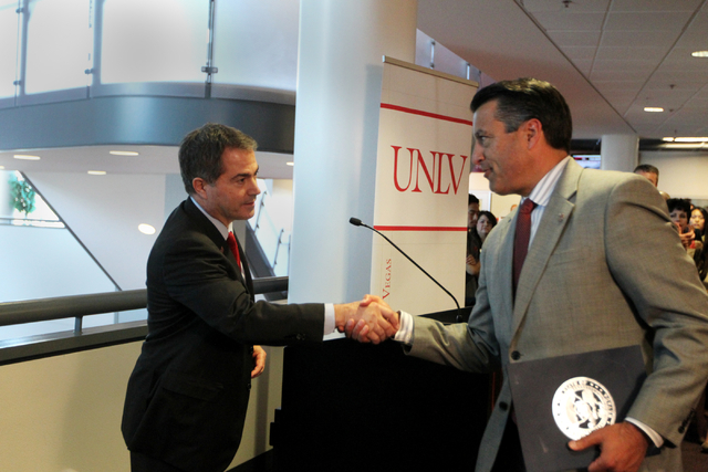 UNLV President Len Jessup, left, shakes hands with Governor Brian Sandoval at UNLV on Thursday, June 10, 2015, in Las Vegas. The bill provides funds for UNLV's law, medical, business and hotel sch ...