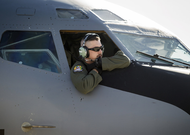 1st L. Ryan Merrifield from the 91st Air Refueling Squadron leans out the cockpit of a KC-135 Stratotanker before take off at Nellis Air Force Base on Wednesday, June 10, 2015. The squad from MacD ...