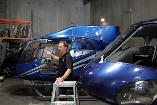 Doug Scroggins talks about the EC-130, left, which was used in "Jurassic World" on Wednesday, June 17, 2015, in Las Vegas. Scroggins Aviation supplies helicopters for movies such as "Jurassic Worl ...
