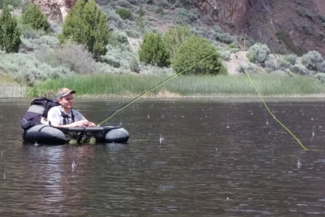 Hyrum Nielsen searches the waters of Eagle Valley Reservoir for trout during a recent outing to the Lincoln County water. The reservoir holds three species of trout and largemouth bass. (C. Dougla ...