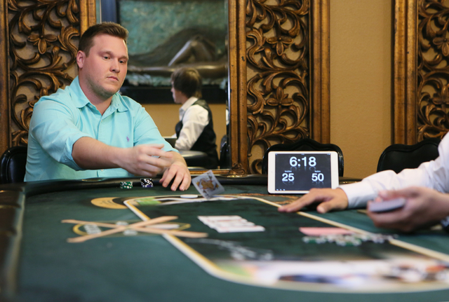 Bradley Anderson throws his cards in while playing in a heads up tournament with professional poker player Jamie Gold at baseball great Jose Canseco's home on Friday, June 26, 2015, in Las Vegas.  ...