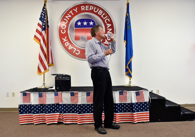 Ohio Gov. John Kasich sips some water as he speaks at the Clark County Republican Party headquarters in Las Vegas on Thursday, June 11, 2015. Kasich is traveling the country before he makes his fi ...