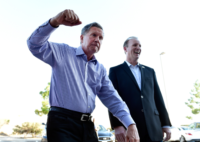 Ohio Gov. John Kasich, left, greets a supporter with a fist bump as Clark County Republican Party Chairman David McKeon looks on at the Clark County Republican Party headquarters in Las Vegas on T ...