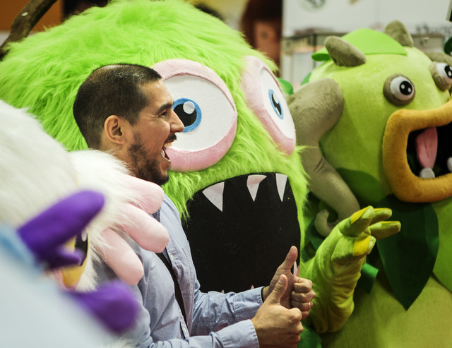 Benjamin Soto poises with the My Singing Monsters during the Licensing Expo 2015 at the Mandalay Bay Convention Center, 3950 South Las Vegas Boulevard on Tuesday, June 9, 2015. Over 15,000 attende ...