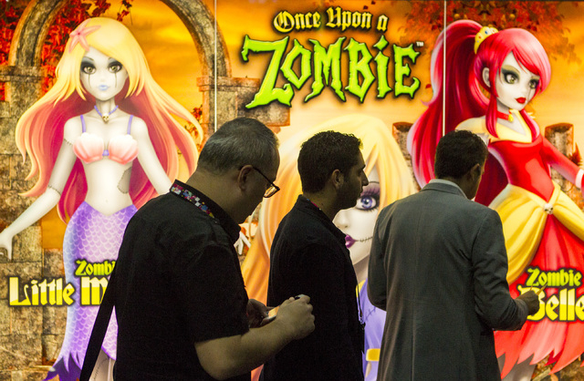Men walk pass the The Toon Studio of Beverly Hills booth during the Licensing Expo 2015 at Mandalay Bay Convention Center, 3950 South Las Vegas Boulevard on Tuesday, June 9, 2015. Over 15,000 atte ...
