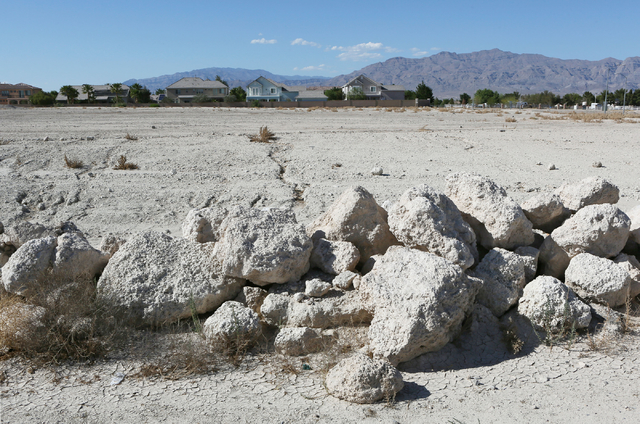An undeveloped parcel of land can be seen at the corner of Centennial Parkway and Tenaya Way near homes Wednesday, May 27, 2015, in Las Vegas. Shiron Development LLC proposed a three-story and 261 ...