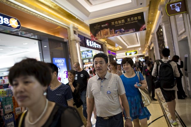 Tourists walk inside a shopping mall at Galaxy Macau resort in Macau, China, on Wednesday, May 27, 2015. As revenue plummets at China's only legal gambling hub, global casino operators have a new  ...