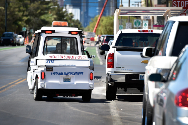 Parking enforcement officer Joshua Kuykendall chalks a vehicle's tire as he patrols along 6th Street in downtown Las Vegas on Friday, June 12, 2015. (David Becker/Las Vegas Review-Journal)