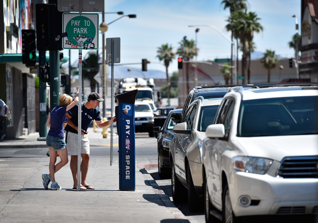 Motorists pay at a parking meter along 6th Street in downtown Las Vegas on Friday, June 12, 2015. (David Becker/Las Vegas Review-Journal)