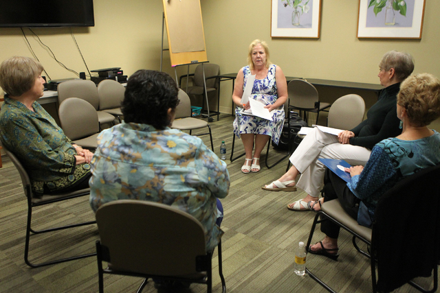 Laurie Moore Moss, center, peer counseling coordinator for the St. Rose Dominican Hospitals Peer Counseling program, speaks to fellow counselors during a meeting at the Barbara Greenspun WomensCar ...