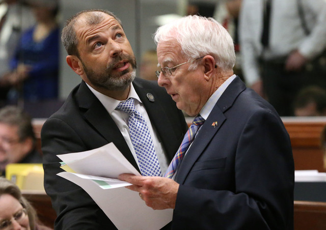 Nevada Assembly Republicans Paul Anderson, left, and Lynn Stewart work on the Assembly floor as the final chaotic minutes of the session tick down at the Legislative Building in Carson City, Nev., ...