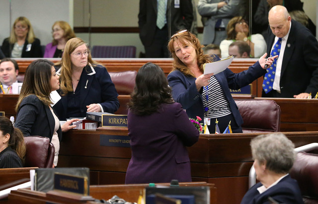 Nevada Assembly Democrats, from left, Teresa Benitez Thompson, Maggie Carlton, Irene Bustamante Adams and Marilyn Kirkpatrick talk on the Assembly floor in the final chaotic minutes of the session ...