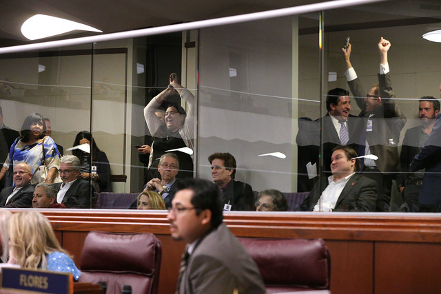 A group of lobbyist react to the passage of the Clark County School District school breakup bill on the Assembly floor in the final seconds of the session at the Legislative Building in Carson Cit ...