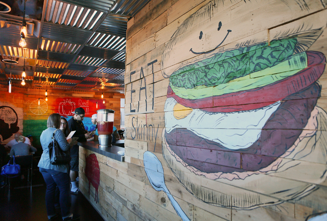 Customers wait at the counter near a mural at SkinnyFats Saturday, Dec. 6, 2014, in Las Vegas. (Ronda Churchill/Las Vegas Review-Journal)