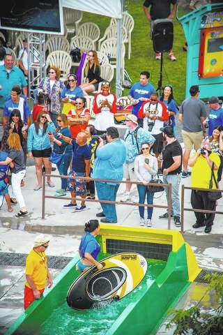 Onlookers cheer for Tracy Lee, social media expert/photographer for the Nevada Partnership for Homeless Youth, during Wet‘n’Wild’s Celebrity Slideboarding Competition fundraiser, which kicke ...