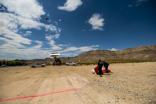 Two skydivers pick up their parachutes after landing during the groundbreaking ceremony of The Cliffs, a new development in Summerlin, in Las Vegas on Wednesday, June 10, 2015. (Joshua Dahl/Las Ve ...