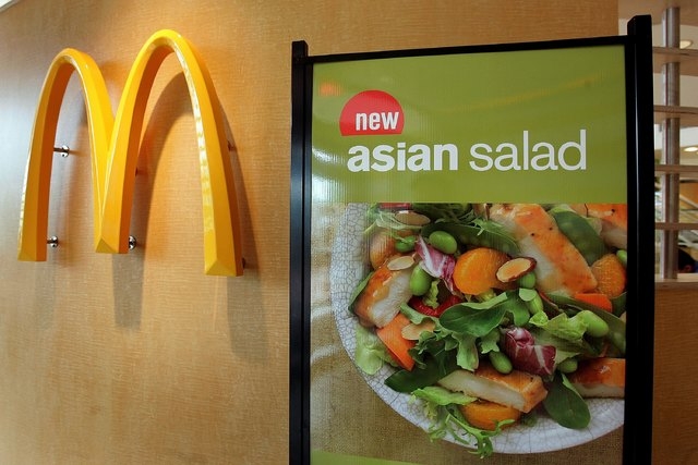 A display for McDonald's Asian Salad, part a their new "Go Active Happy Meal," is visible next to a McDonald's logo April 25, 2006 in a McDonald's restaurant in Oakbrook, Illinois. (Photo by Tim B ...