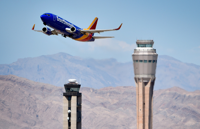 A Southwest Airline passenger jet takes off from McCarran International Airport under the control of the smaller of the two federal air traffic control towers on Monday, June 8, 2015. The new 352- ...