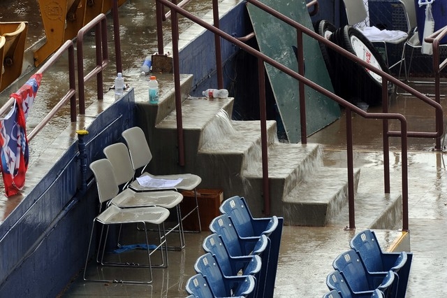 Rain water pours down steps at Cashman Field as a thunderstorm moves overhead after a minor league baseball game between the Las Vegas 51s and the Reno Aces was played Sunday June 14, 2015. Las Ve ...