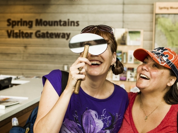 Chris Collier, left, and Wendy Lyons holds polarized glass to view glass panel at the Spring Mountain Visitor Gateway, 2750 Kyle Canyon Road in Mount Charleston, on Thursday, July 9,2015. The 128- ...