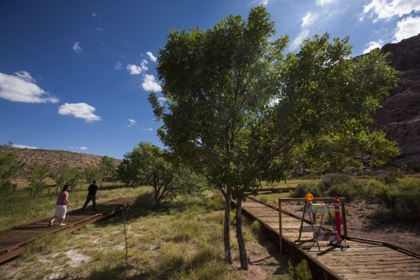 A blocked off portion of the boardwalk is seen, right, as Nan and John Lin walk by at the Red Springs picnic area in the Red Rock Canyon National Conservation Area on Tuesday, July 21, 2015. A por ...