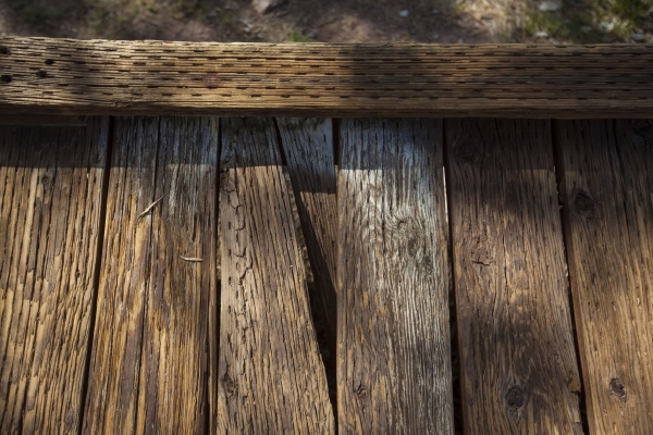 Part of broken wooden plank is seen on the boardwalk as people walk by at the Red Springs picnic area in the Red Rock Canyon National Conservation Area on Tuesday, July 21, 2015. A portion of the  ...