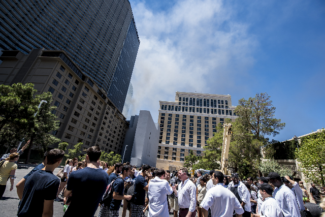 Guest and employees are evacuated due to a fire at the pool of The Cosmopolitan hotel-casino on the strip in Las Vegas on Saturday, July 25, 2015. (Joshua Dahl/Las Vegas Review-Journal)