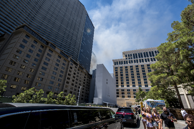 Guest and employees are evacuated due to a fire at the pool of The Cosmopolitan hotel-casino on the strip in Las Vegas on Saturday, July 25, 2015. (Joshua Dahl/Las Vegas Review-Journal)