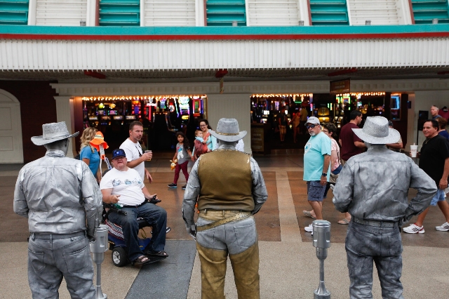 The Silver and Gold statues perform on Fremont Street on Wednesday, July 29 2015. The city hopes to set up zones for street performers on Fremont Street.