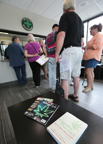 Customers fill prescriptions at Silver State Relief in Sparks on Friday morning, July 31, 2015. More than 50 people with state-authorized medical cards lined up for the opening of the first medica ...