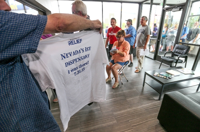 A customer who declined to give his name shows off a t-shirt he received after filling a prescription at Silver State Relief, in Sparks on Friday morning, July 31, 2015. More than 50 people with s ...