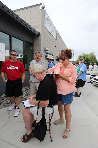 Jerry Young and Barbara Dunn fill out paperwork while waiting for the opening of Silver State Relief in Sparks on Friday, July 31, 2015. More than 50 people with state-authorized medical cards lin ...