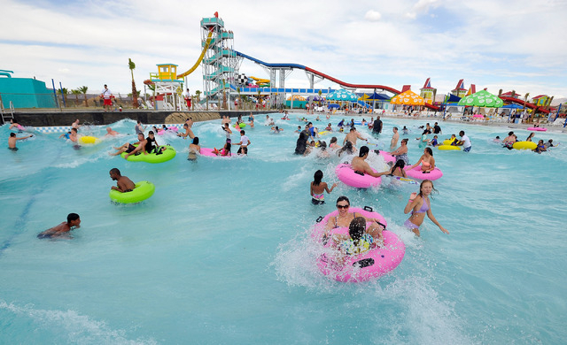 Patrons ride the swells with tubes in the wave pool during the opening day of Cowabunga Bay in Henderson on Friday, July 4, 2014. (David Becker/Las Vegas Review-Journal)