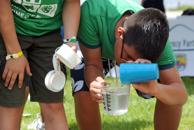 Y Summer Campers participate in a water conservation learning activity. Mayor Carolyn G. Goodman joined the Bureau of Land Management director Neil Kornze, and president & CEO of the YMCA of South ...