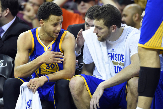 Jun 11, 2015; Cleveland, OH, USA; Golden State Warriors guard Stephen Curry (30) talks to forward David Lee (10) on the bench during the fourth quarter against the Cleveland Cavaliers in game four ...