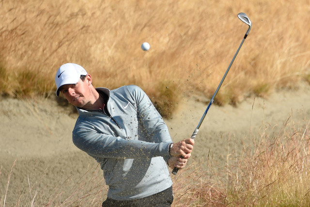 Jun 17, 2015; University Place, WA, USA; Rory McIlroy hits out of the bunker on the 15th hole during practice rounds on Wednesday at Chambers Bay. (John David Mercer-USA TODAY Sports)