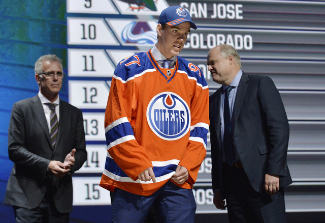 Jun 26, 2015; Sunrise, FL, USA; Connor McDavid walks off the stage after being selected as the number one overall pick to the Edmonton Oilers in the first round of the 2015 NHL Draft at BB&T Cente ...