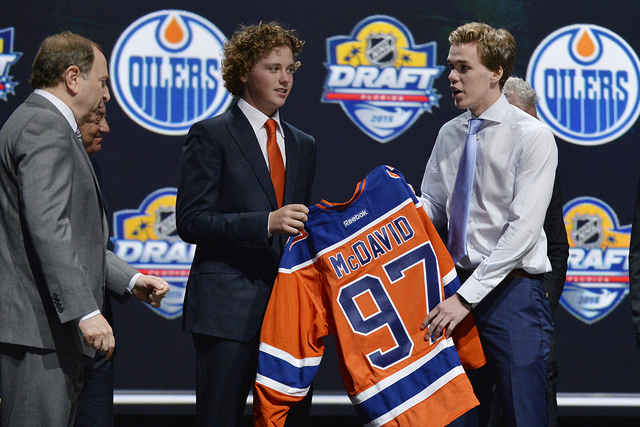 Jun 26, 2015; Sunrise, FL, USA; Connor McDavid is presented with a team jersey after being selected as the number one overall pick to the Edmonton Oilers in the first round of the 2015 NHL Draft a ...