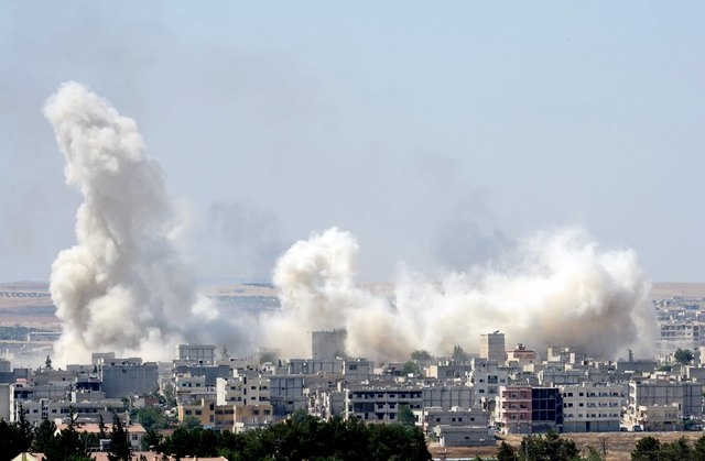 Smoke rises in the Syrian town of Kobani, as pictured from the Turkish side of the border near Suruc, Sanliurfa province, Turkey, June 27, 2015. An explosion hit the Syrian town of Kobani on Satur ...