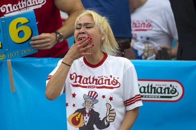 Miki Sudo, winner of Nathan's Famous Hot Dog Eating Contest in the Women's division, eats a hot dog during the competition in Brooklyn, New York July 4, 2015. Sudo finished with a total of 38 hot  ...