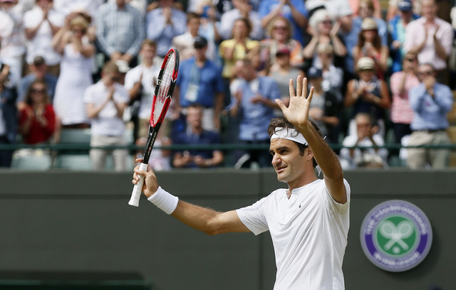 Roger Federer of Switzerland celebrates after winning his match against Gilles Simon of France at the Wimbledon Tennis Championships in London, July 8, 2015. (REUTERS/Stefan Wermuth)