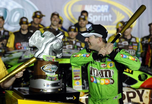 Jul 11, 2015; Sparta, KY, USA; Sprint Cup Series driver Kyle Busch (18) celebrates with a Louisville Slugger bat after winning the Quaker State 400 at Kentucky Speedway. Mandatory Credit: Christop ...