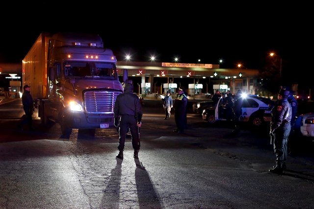 Policemen inspect a trailer at a checkpoint outside the Altiplano Federal Penitentiary, after drug lord Joaquin 'El Chapo' Guzman escaped, in Almoloya de Juarez, on the outskirts of Mexico City, J ...