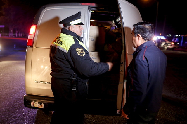 A policeman inspects a van at a checkpoint outside the Altiplano Federal Penitentiary, after drug lord Joaquin 'El Chapo' Guzman escaped, in Almoloya de Juarez, on the outskirts of Mexico City, Ju ...