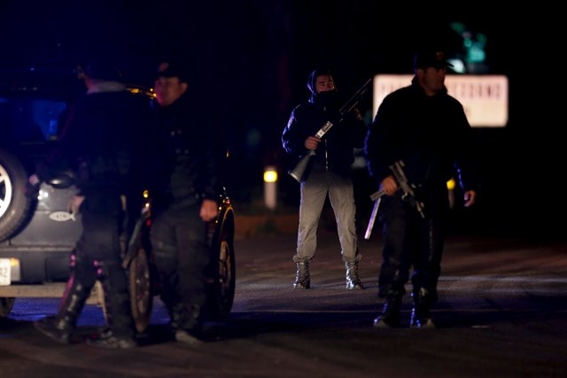 Policemen stand guard at a checkpoint outside the Altiplano Federal Penitentiary, after drug lord Joaquin 'El Chapo' Guzman escaped, in Almoloya de Juarez, on the outskirts of Mexico City, July 12 ...
