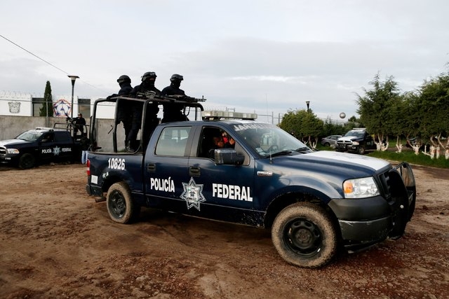 Police keep watch outside the Altiplano Federal Penitentiary, after drug lord Joaquin "El Chapo" Guzman escaped, in Almoloya de Juarez, on the outskirts of Mexico City, July 12, 2015. Mexico's mos ...
